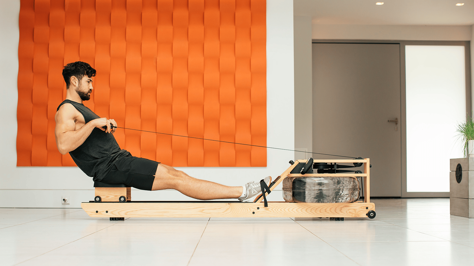 Man working out on WaterRower Lite