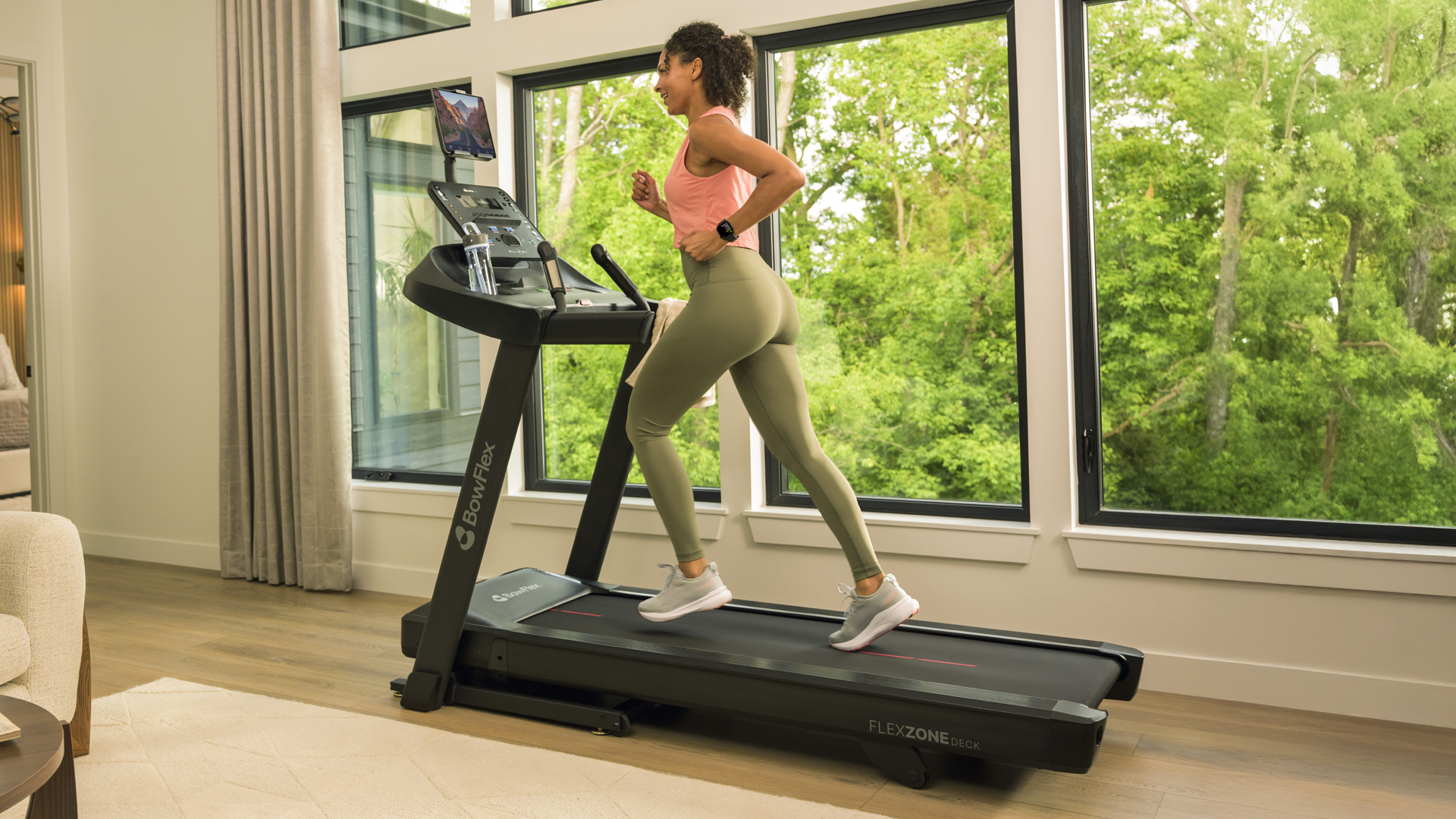 Person running on BowFLex T6 treadmill in home