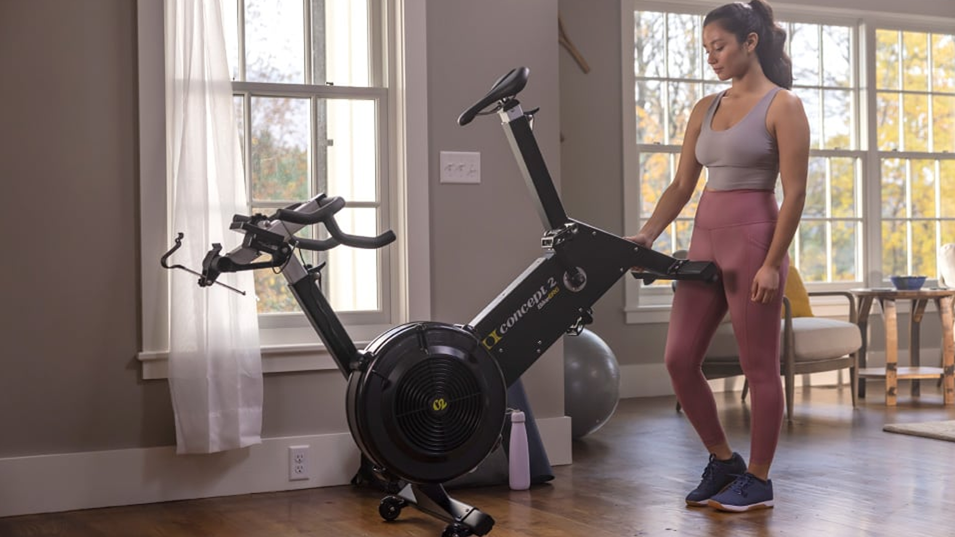 Woman using wheels to move the Concept2 BikeErg