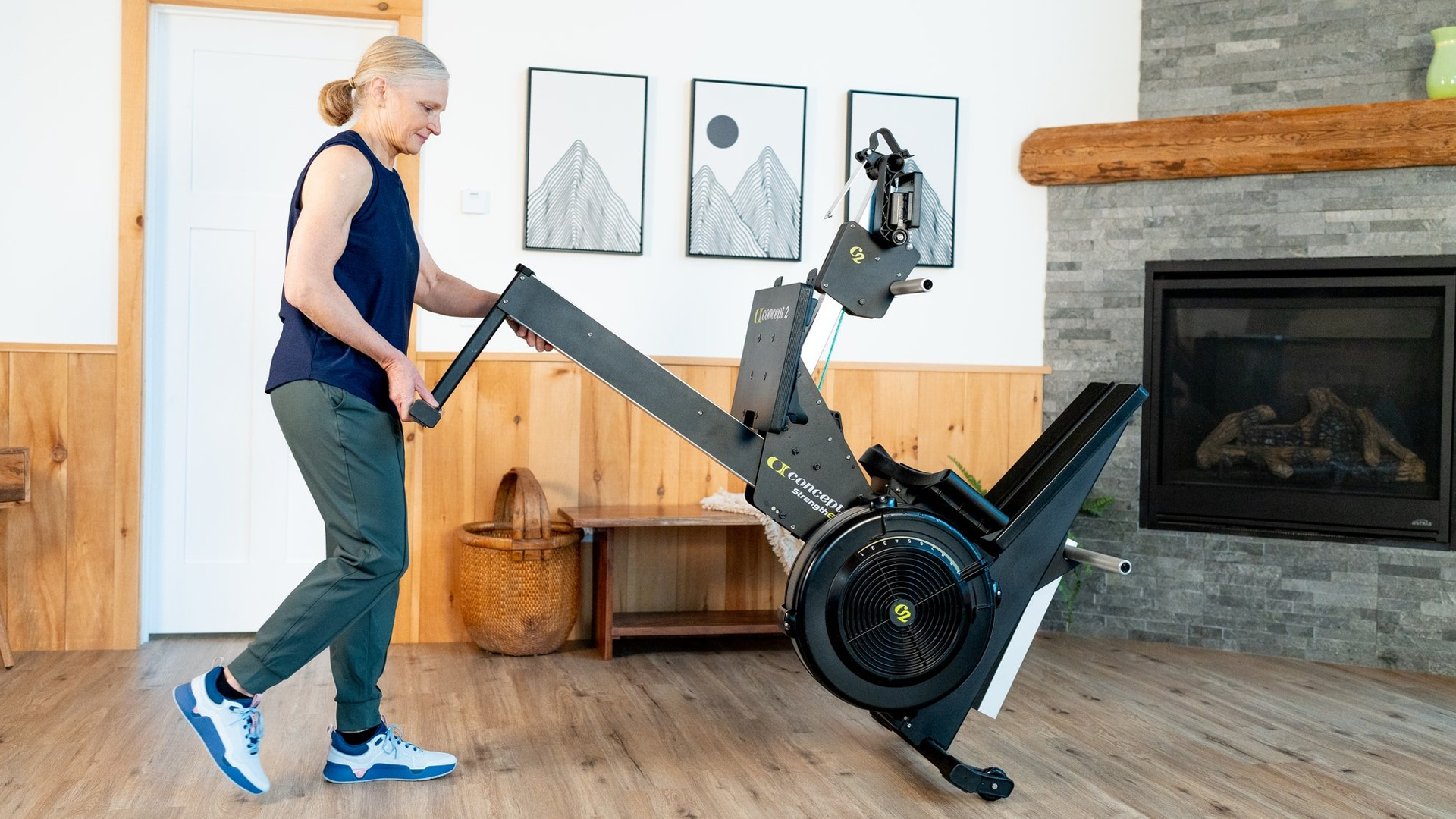 Woman using wheels to move the Concept2 StrengthErg