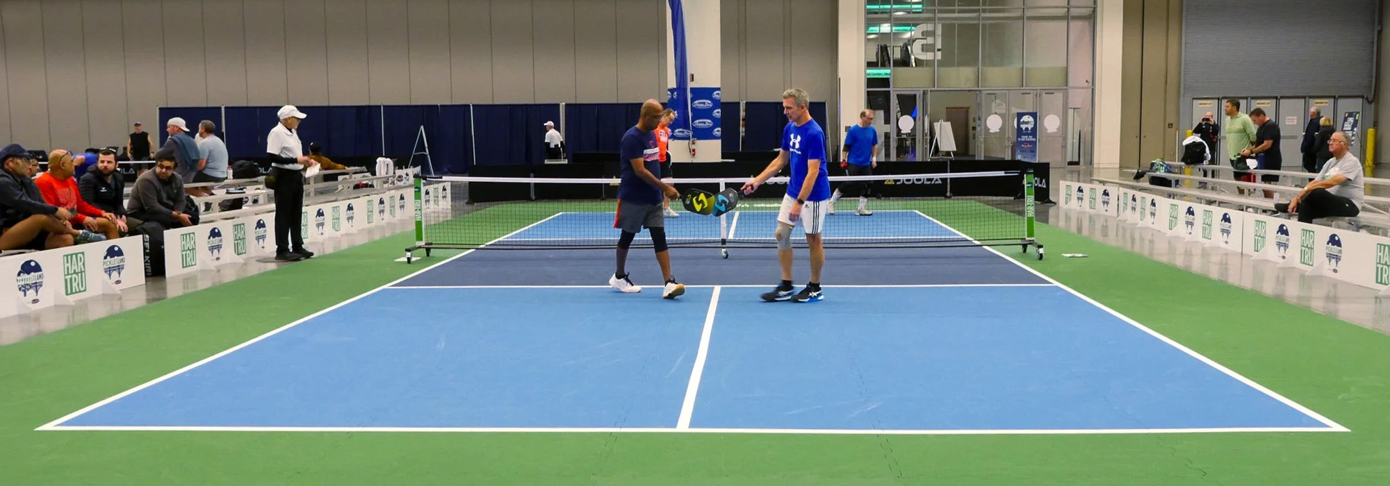 Two men meeting on the MODcourt Pickle sport court