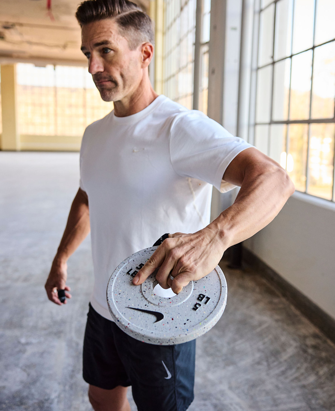 Athletic man holding Nike Grind Change Plate