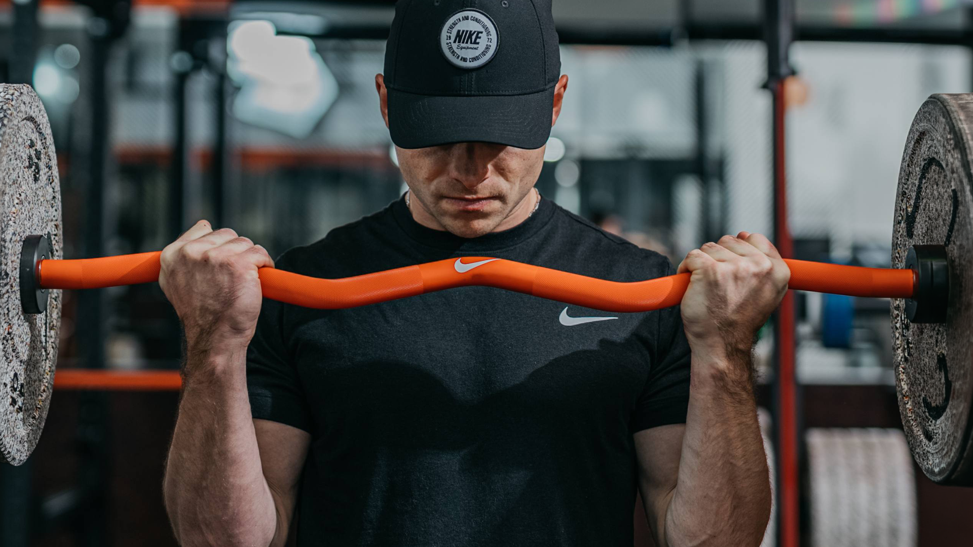 Nike Strength Shield Curl Bar in a strength training space