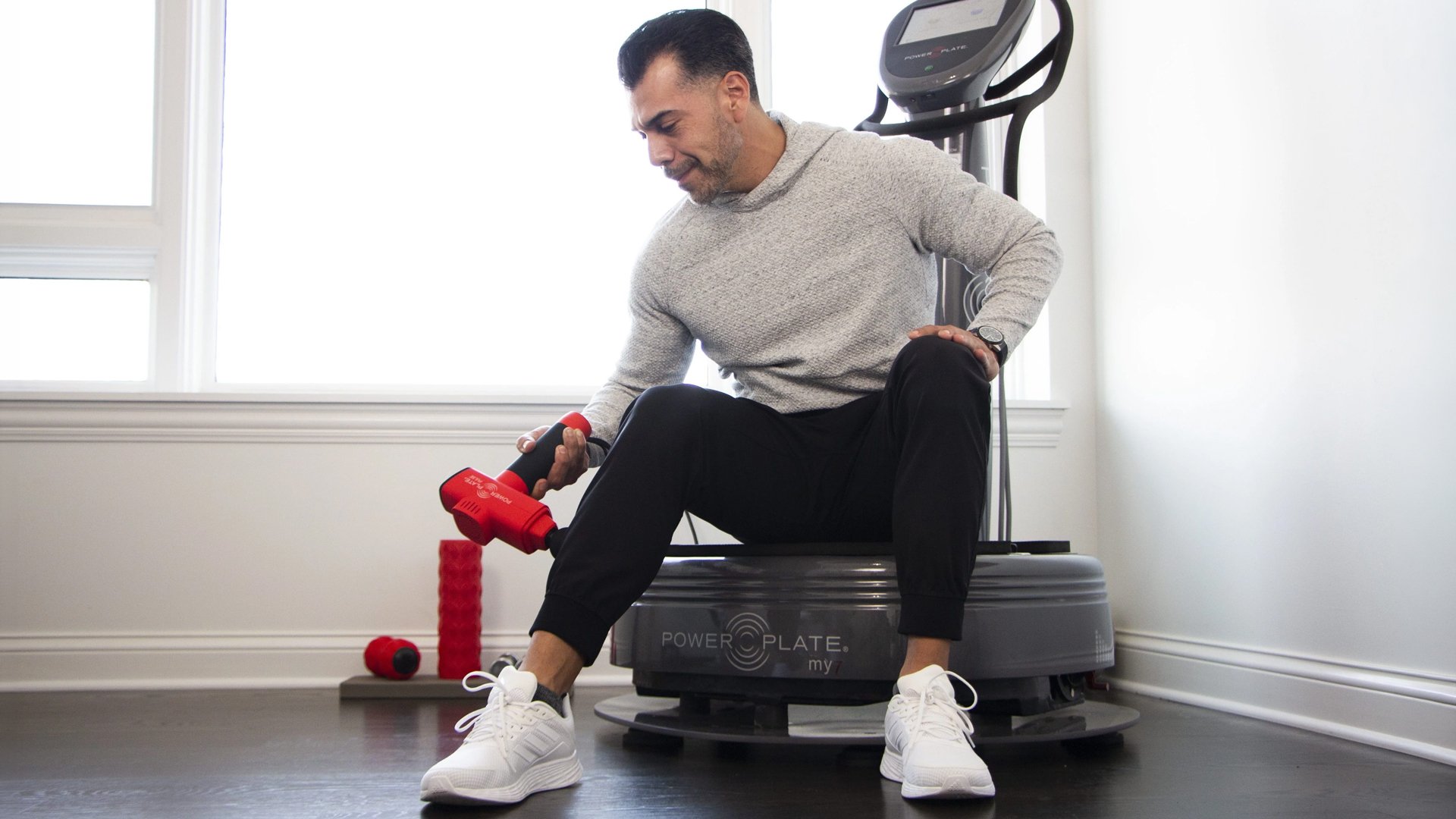 Man using the Power Plate Pulse massager on his calf