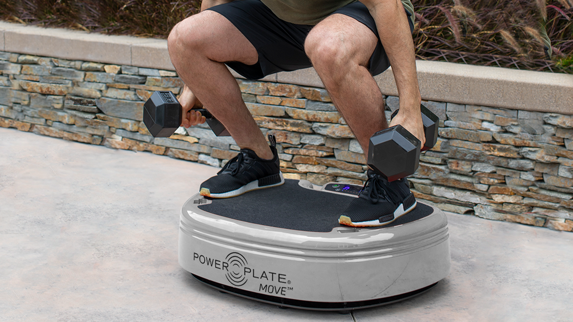 Close of up male squatting weights on Power Plate MOVE