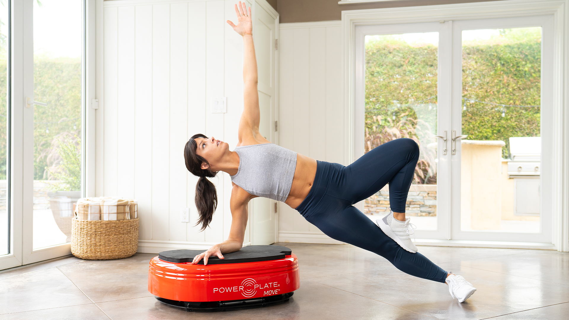 Woman working out on Power Plate MOVE in home