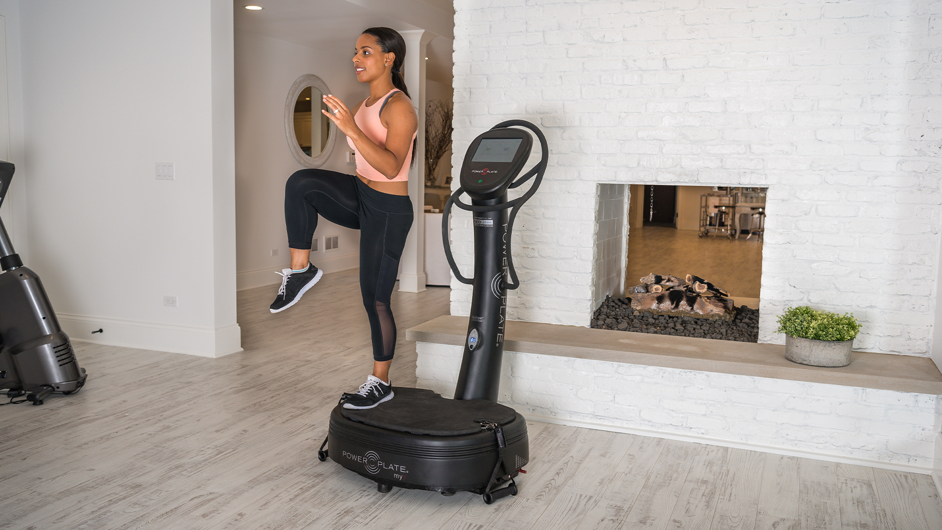 Woman working out on Power Plate my8 in living room