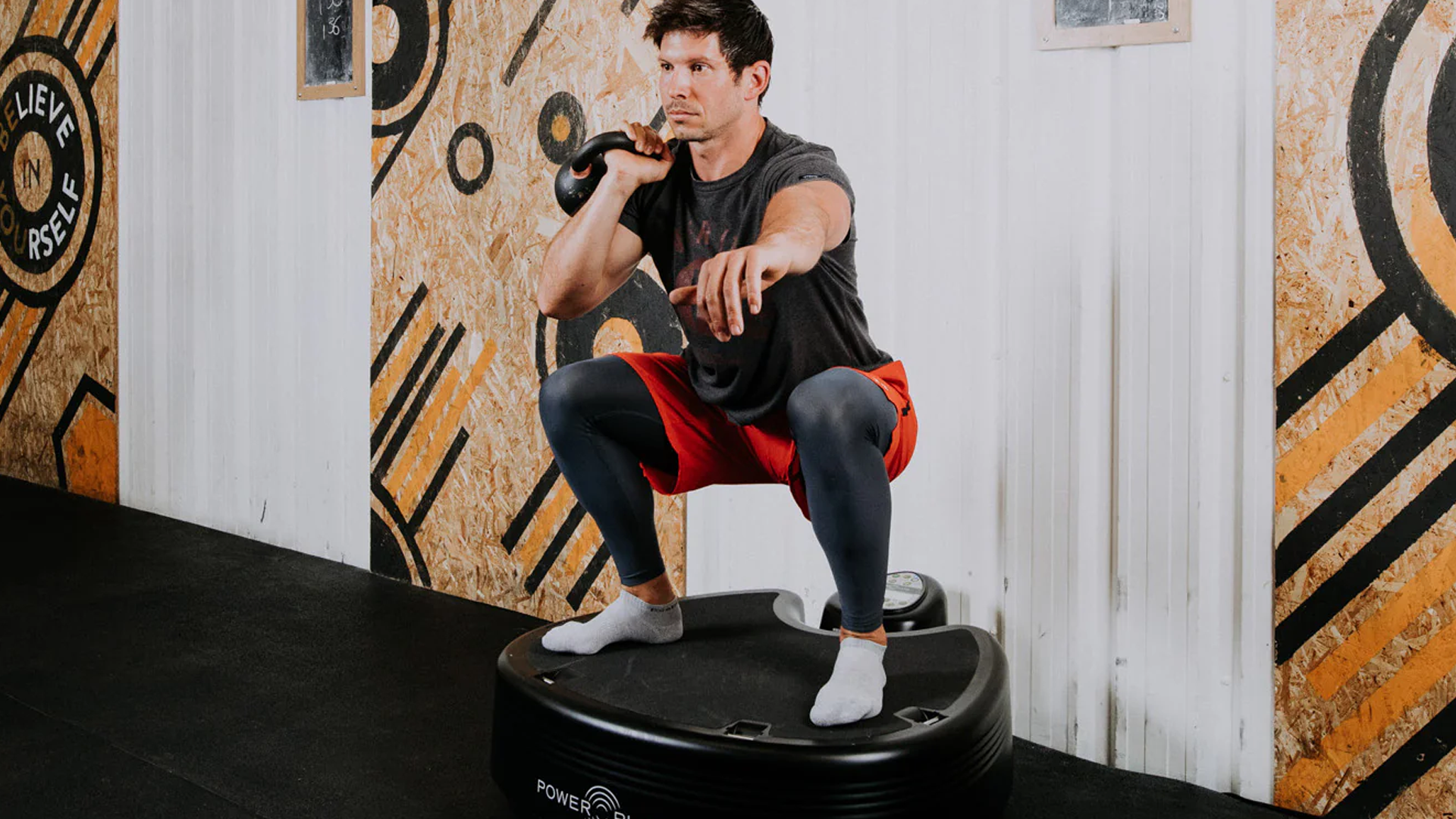 Man using Power Plate Pro5HP in gym