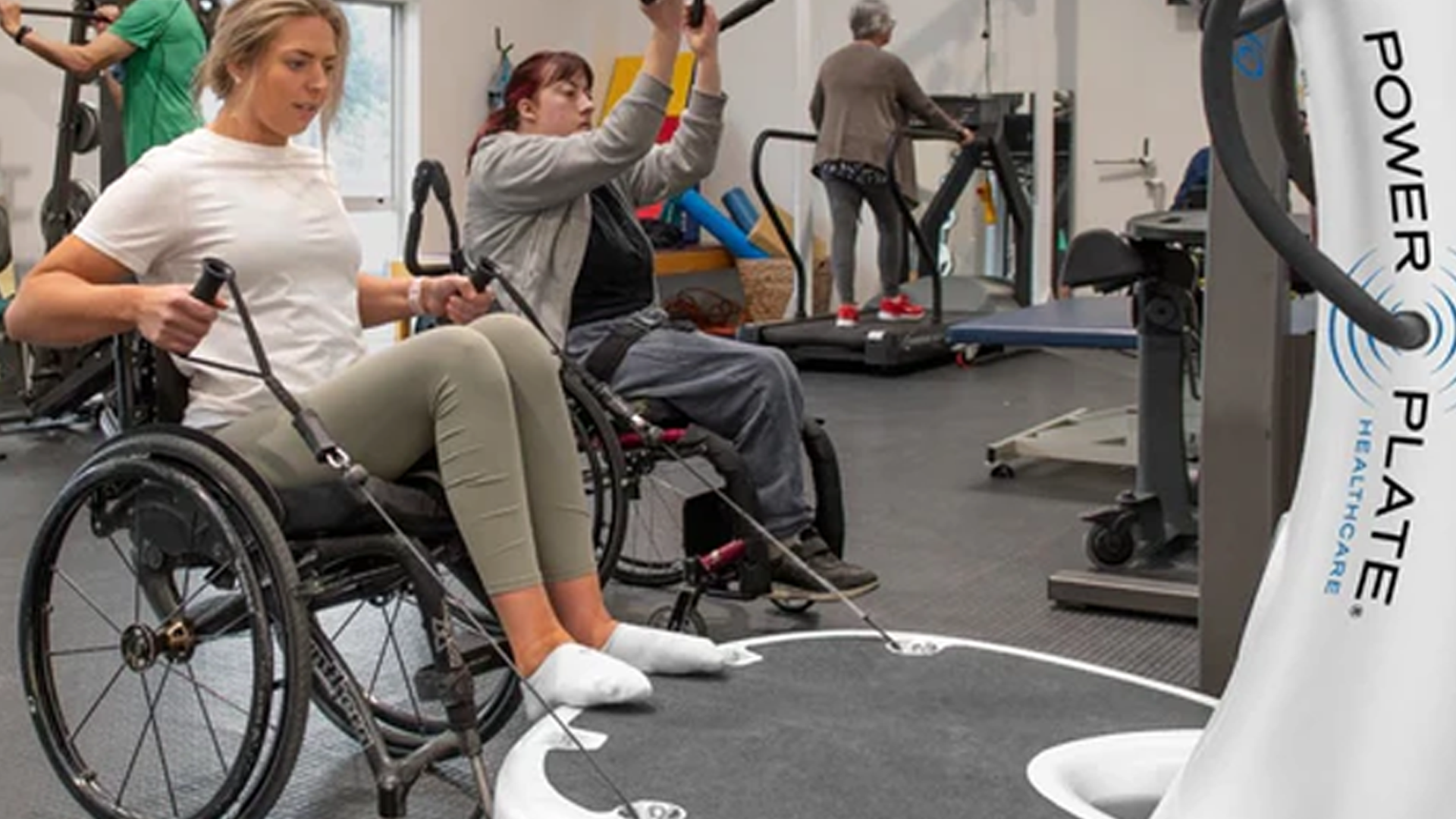 Woman using Power Plate Pro7HC in medical facility