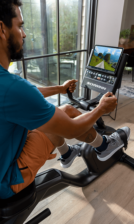 Man working out on Schwinn 290 Recumbent Bike in home