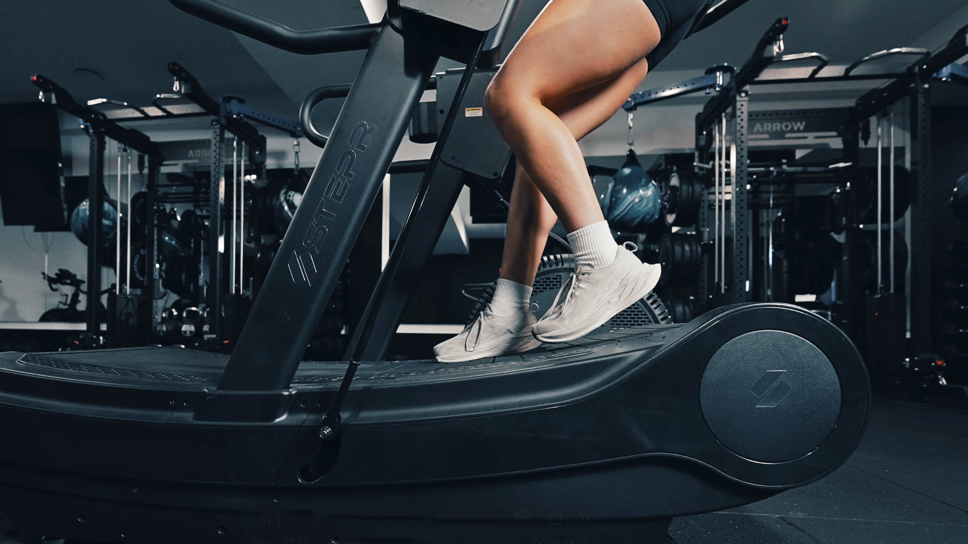 Athlete sprinting and sled pushing on the STEPR Treadsled XL