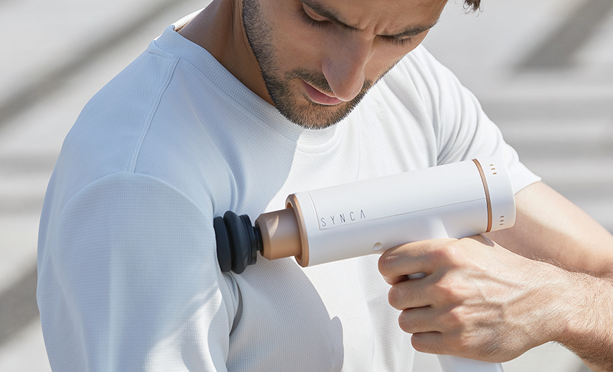 Man Using Synca Wellness Kitta Massager