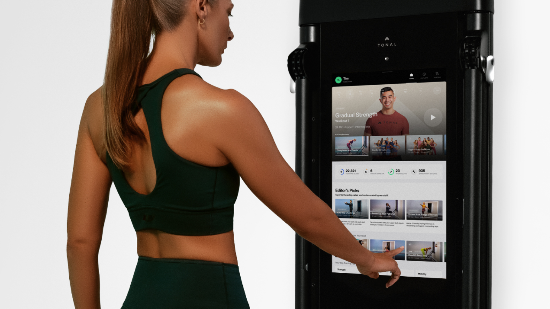 Woman browsing trainer exercises on Tonal 2
