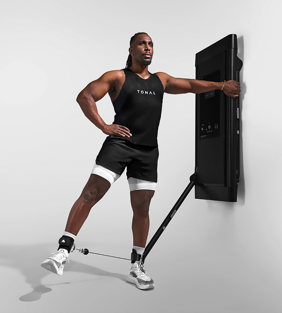 Man doing leg movement with Tonal Ankle Straps