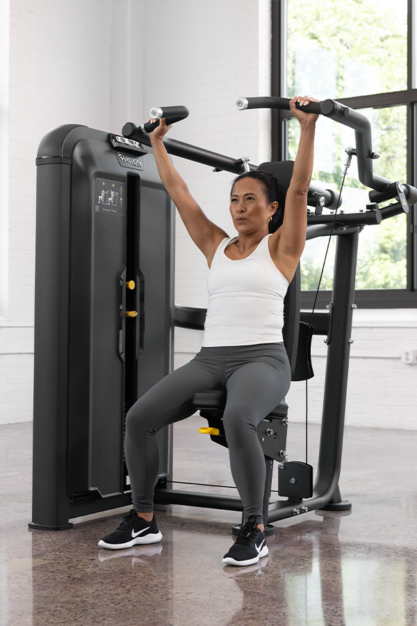 Woman using Vision Fitness Keystone Shoulder Press