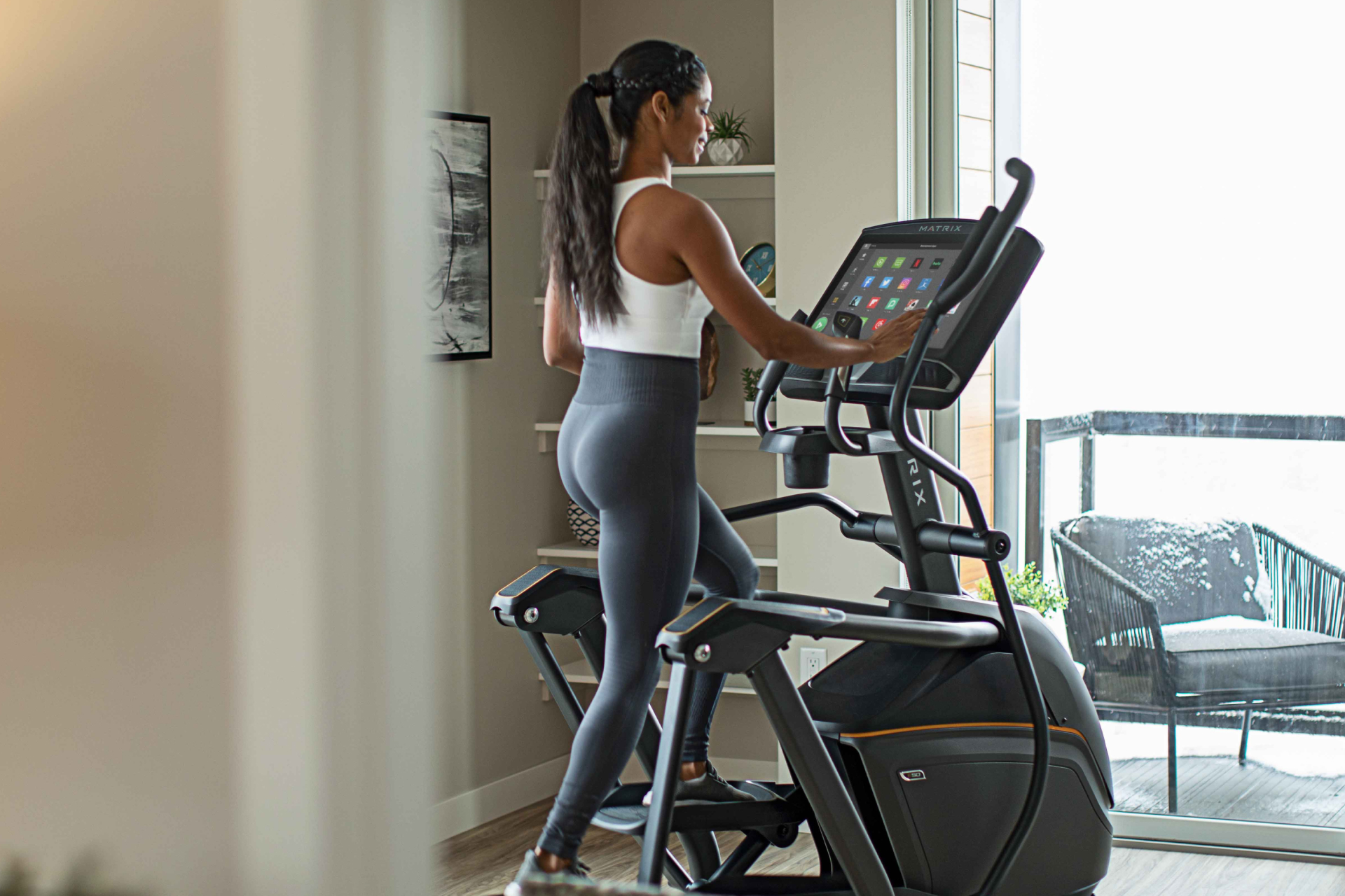 Woman running on Matrix treadmill in home
