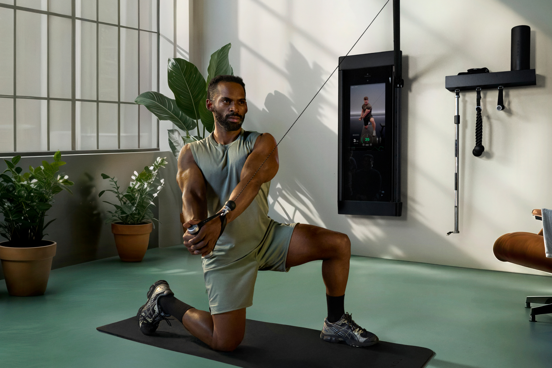 Man using his Tonal 2 Smart Gym in his workout room