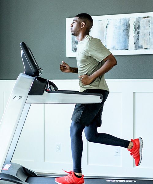 Man running on Landice treadmill in home