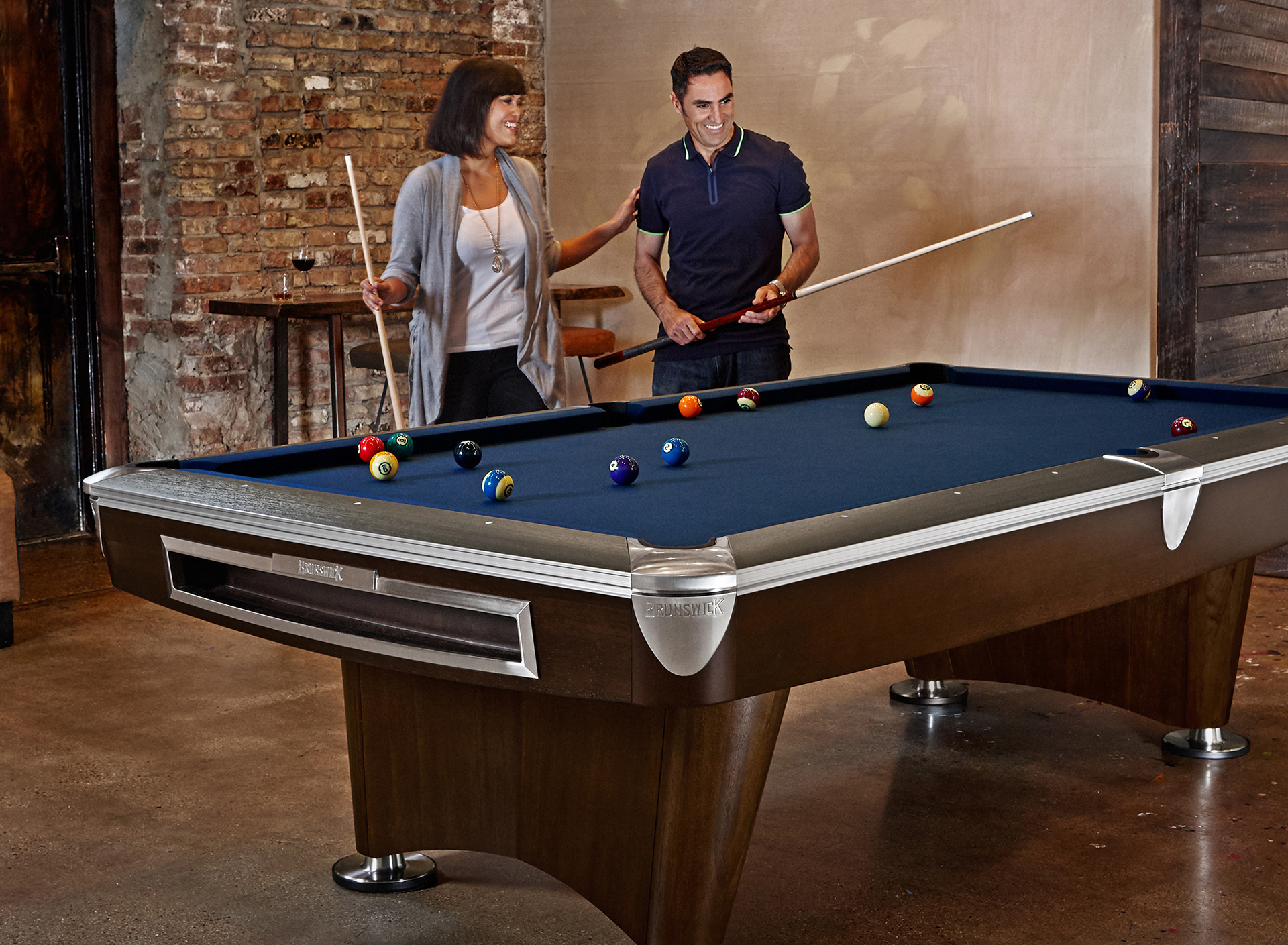 Couple playing billiards at home