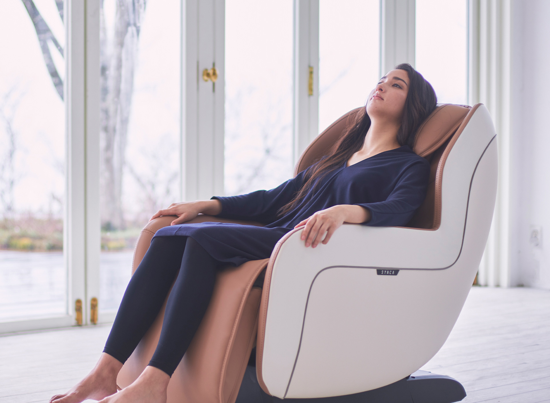 Woman relaxing in massage chair at home