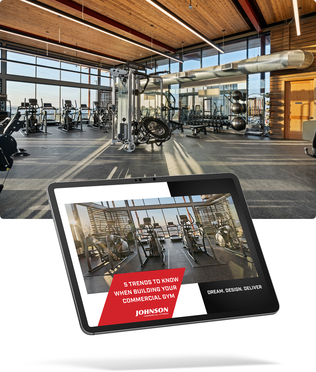 tablet showing the whitepaper cover with a photo of a commercial gym in the background