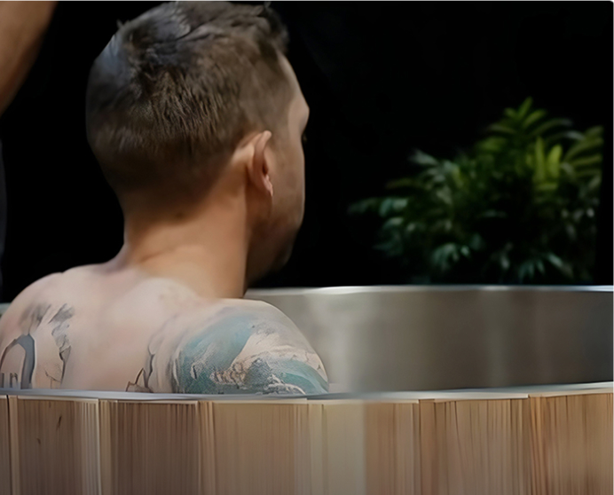 Man sitting in cold plunge tub