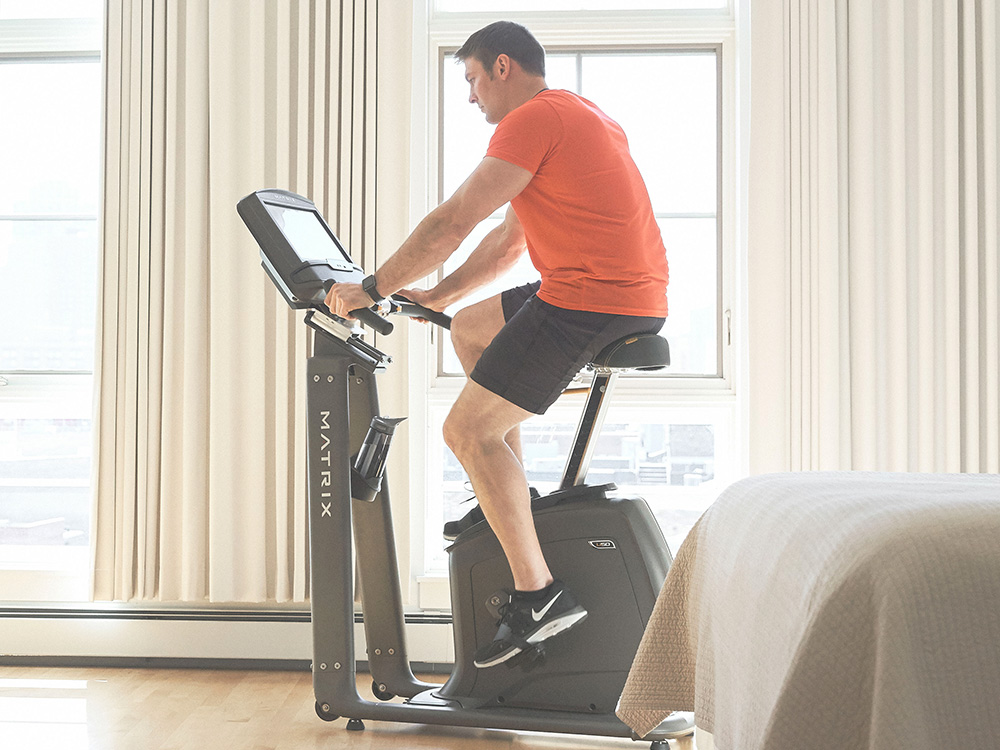 Man on Upright Exercise Bike doing a HIIT exercise bike workout